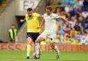 Josh Sargent and Elliott Moore compete for the ball