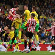 Norwich City's Shane Duffy (centre) attempts a shot at goal