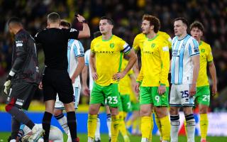 Referee James Bell shows a red card to Norwich City's Kenny McLean during the Sky Bet Championship match at Carrow Road, Norwich. Picture date: Sunday October 27, 2024.