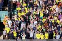 Norwich fans in the glare of the sun during the defeat by Preston