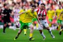 Norwich City's Kellen Fisher (left) and Stoke City's Million Manhoef battle for the ball