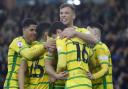 Norwich City players celebrate Christian Fassnacht sealing a 4-1 Championship win over Cardiff City