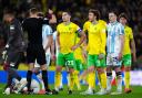 Referee James Bell shows a red card to Norwich City's Kenny McLean during the Sky Bet Championship match at Carrow Road, Norwich. Picture date: Sunday October 27, 2024.