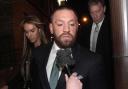 Conor McGregor and partner Dee Devlin leave the High Court in Dublin (Brian Lawless/PA)