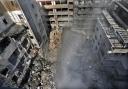 Rescue workers search for victims at the site of an Israeli air strike that hit central Beirut on Saturday (Hussein Malla/AP)