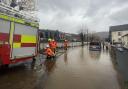 Firefighters pumping water from a street by the River Taff in Pontypridd, Wales, following flooding (George Thompson/PA)