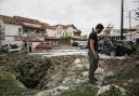 An Israeli police bomb squad inspects the site after a missile fired from Lebanon hit the area in Petah Tikva, on the outskirts of Tel Aviv, Israel (Oded Balilty/AP)