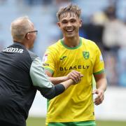 Manchester City loanee Callum Doyle is all smiles with Norwich City assistant head coach Glen Riddersholm