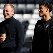 Norwich City head coach Johannes Hoff Thorup shares a joke with Ben Chrisene