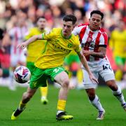 Norwich City's Kellen Fisher (left) and Stoke City's Million Manhoef battle for the ball