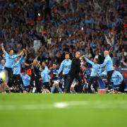 Pep Guardiola, centre, and Manchester City celebrate their Champions League win in 2023 (Martin Rickett/PA)