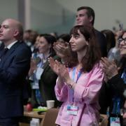 Delegates applaud agreeing on a deal to curb climate change (Joshua A. Bickel/AP)