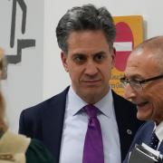 Ed Miliband (centre) speaks with US climate envoy John Podesta (right) at the Cop29 summit in Azerbaijan (Rafiq Maqbool/AP/PA)