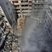 Rescue workers search for victims at the site of an Israeli air strike that hit central Beirut on Saturday (Hussein Malla/AP)