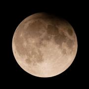 A supermoon with a partial lunar eclipse rises over Lake Michigan in Chicago earlier this year (Kiichiro Sato/AP)