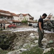 An Israeli police bomb squad inspects the site after a missile fired from Lebanon hit the area in Petah Tikva, on the outskirts of Tel Aviv, Israel (Oded Balilty/AP)