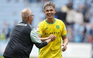 Manchester City loanee Callum Doyle is all smiles with Norwich City assistant head coach Glen Riddersholm